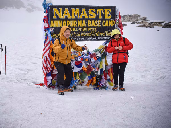 Trekkers posing at Annapurna Base Camp in the Himalayas
